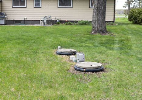 Septic access covers and pipes in a residential yard